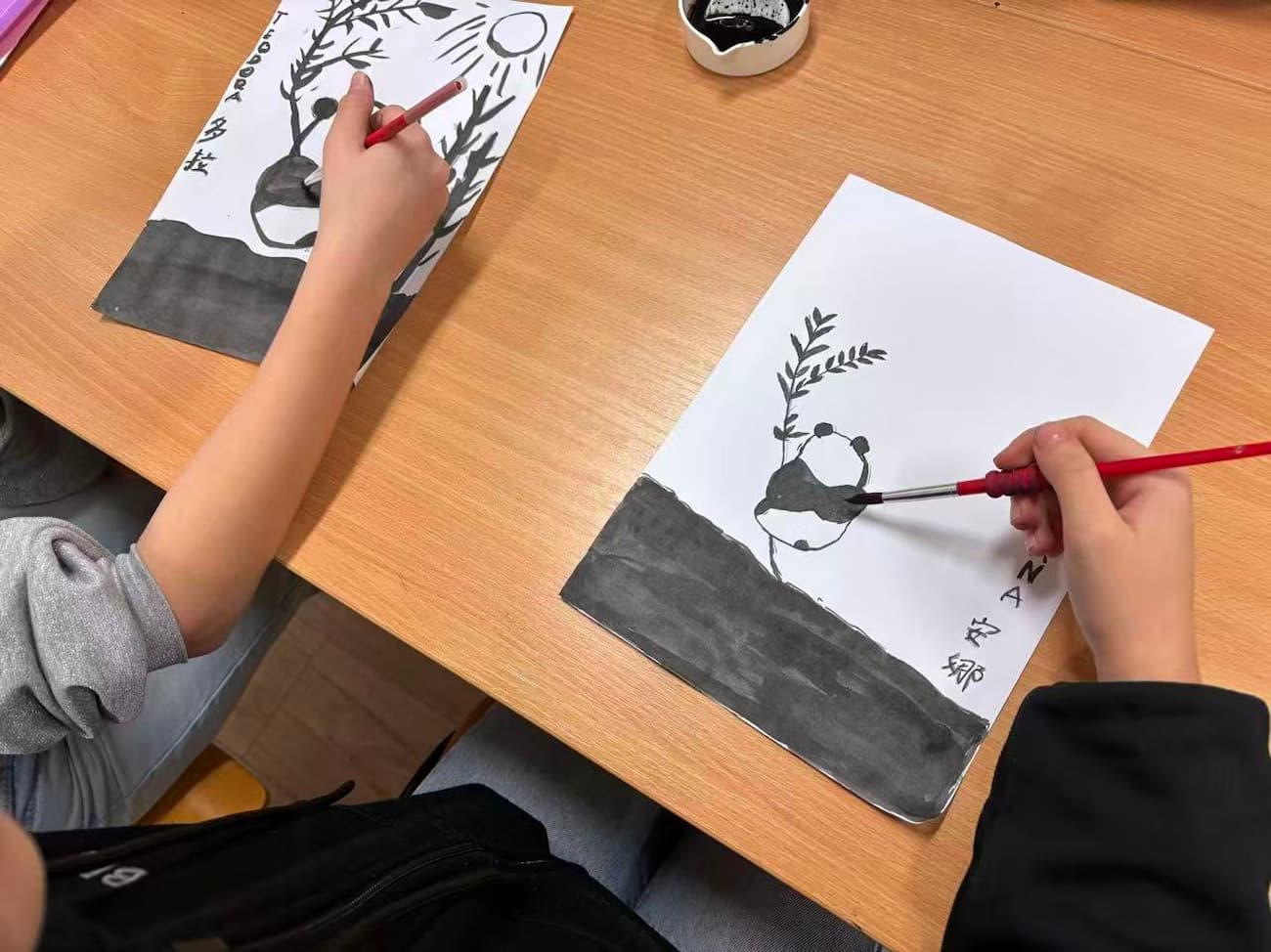Photo 1: Students painting pandas