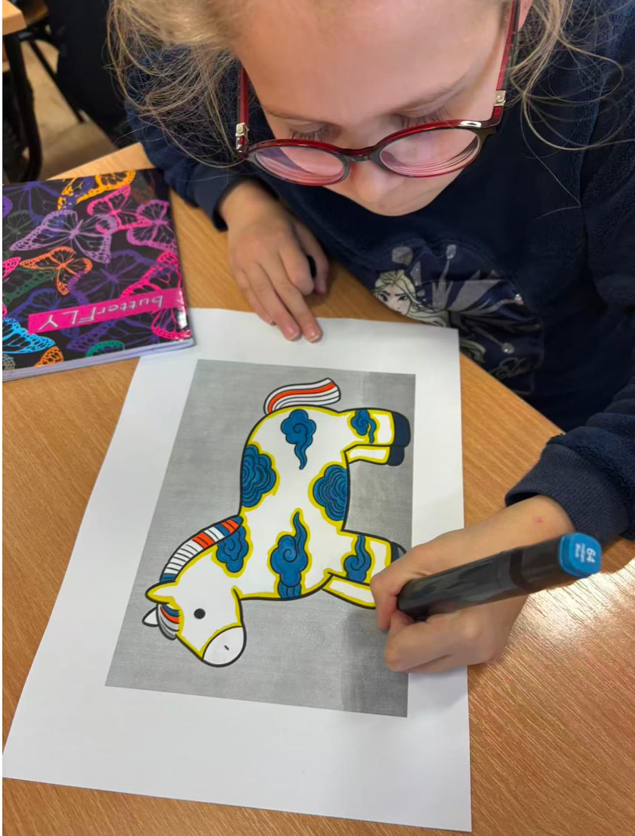 Photo 1: Students coloring the little horse