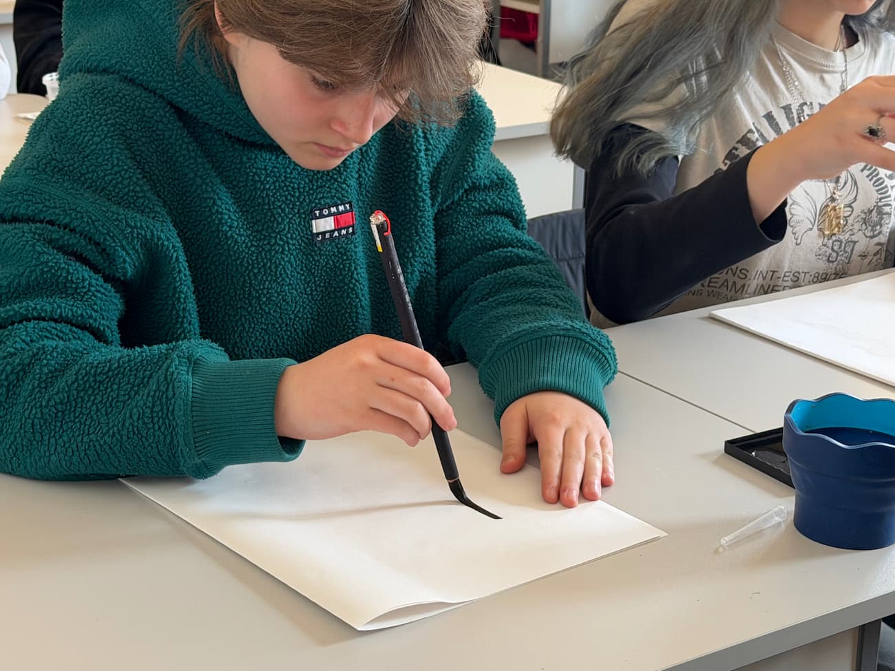 Photo 4 – Students practicing calligraphy